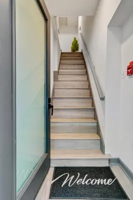 a stairway leading to a door with a welcome mat at Luxurious 2BD family friendly, central in Philadelphia