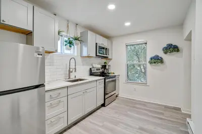 a kitchen with white cabinets and a refrigerator at Luxurious 2BD family friendly, central in Philadelphia