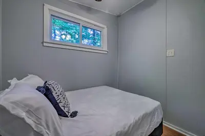 a small bedroom with a bed and a window at 22 Mi to Ski Big Bear! Lake Wallenpaupack Getaway in Greentown