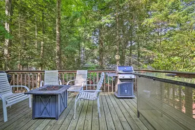 a patio with chairs and a grill on a deck at 22 Mi to Ski Big Bear! Lake Wallenpaupack Getaway in Greentown