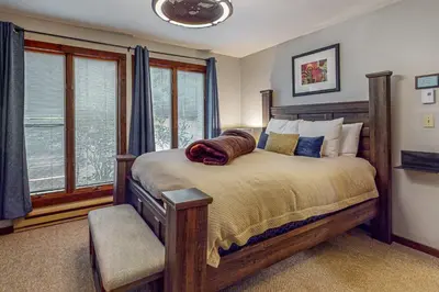 a bedroom with a large bed and a window at Big Boulder Bliss in Lake Harmony