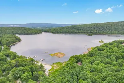 an aerial view of a lake with trees at Big Boulder Bliss in Lake Harmony
