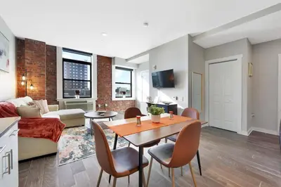 a living room with a table and chairs and a couch at Elegant Main Street Living* Near NYC in Hackensack
