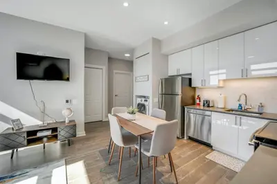 a kitchen with a table and chairs in a room at Stylish 1br Unit. Parking. Easy Ride to NYC in Hackensack