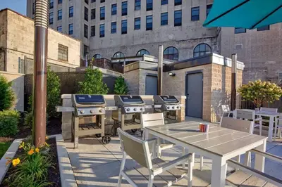 a patio with a barbecue grill and a table and chairs at Stylish 1br Unit. Parking. Easy Ride to NYC in Hackensack