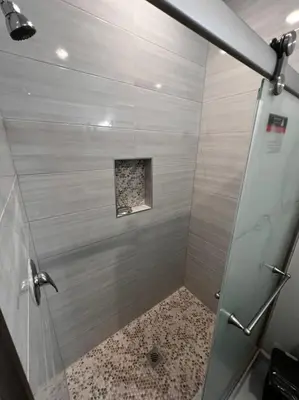 a shower with a glass door in a bathroom at SPRINGVIEW HOMES 12MINS FROM EWR & 3 MINS FROM UNIVERSITY HOSPITAL in Newark