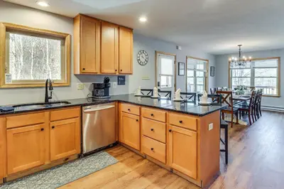 a kitchen with wooden cabinets and a dining room at Hot Tub Soaks! Family Home 6 Mi to Big Boulder Mtn in Albrightsville