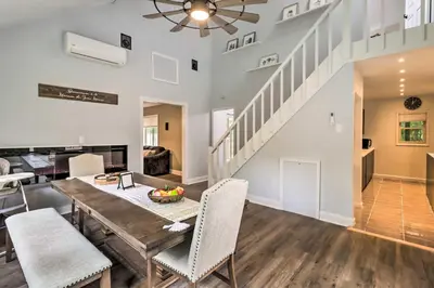 a dining room and living room with a table and chairs at Chic Long Pond Family Home with Fire Pits and Deck! in Long Pond