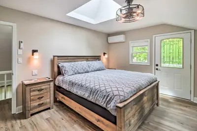a bedroom with a bed and a dresser and a window at Chic Long Pond Family Home with Fire Pits and Deck! in Long Pond
