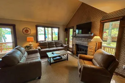 a living room with leather furniture and a fireplace at Big Boulder Lake Townhome in Lake Harmony