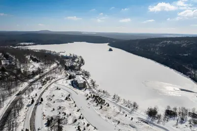 an aerial view of a river with snow and trees at Big Boulder Lake Townhome in Lake Harmony