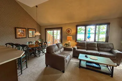 a living room with a couch and a table at Big Boulder Lake Townhome in Lake Harmony