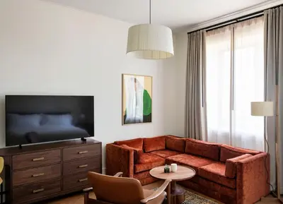 a living room with a couch and a bed at The Quoin Hotel in Wilmington