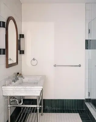 a white bathroom with a sink and a shower at The Quoin Hotel in Wilmington
