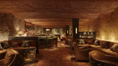 a lobby with couches and a bar in the background at The Quoin Hotel in Wilmington