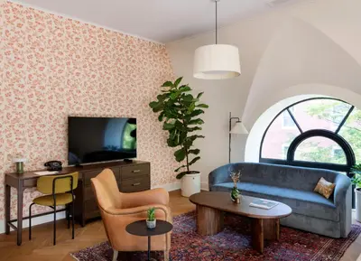 a living room with a blue couch and a table at The Quoin Hotel in Wilmington