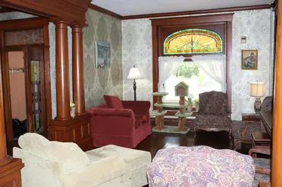 a living room filled with furniture and a stained glass window at VAAST Bed & Breakfast in Adamstown