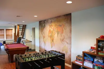 a room with a map on the wall and a pool table at VAAST Bed & Breakfast in Adamstown
