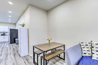 a living room with a table and a refrigerator at Philadelphia Townhome Less Than 8 Mi to Center City! in Philadelphia