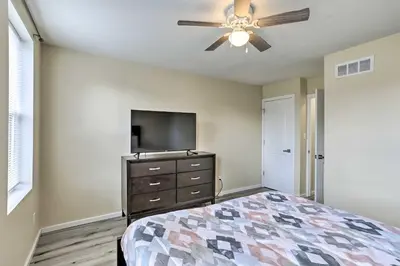 a bedroom with a bed and a flat screen tv at Philadelphia Townhome Less Than 8 Mi to Center City! in Philadelphia