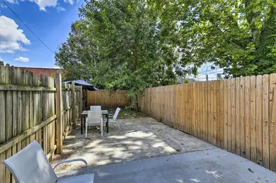 a backyard with a fence and a table and chairs at Philadelphia Townhome Less Than 8 Mi to Center City! in Philadelphia