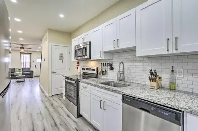 a kitchen with white cabinets and stainless steel appliances at Philadelphia Townhome Less Than 8 Mi to Center City! in Philadelphia