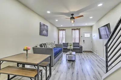 a living room with a couch and a table at Philadelphia Townhome Less Than 8 Mi to Center City! in Philadelphia