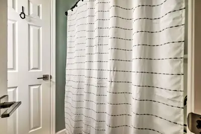 a white shower curtain in a bathroom with a door at Hot Tub, Fire Pit and Barrel Sauna Poconos Abode in Long Pond