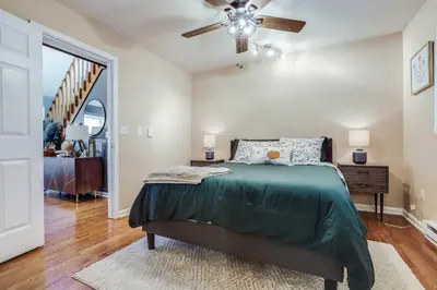 a bedroom with a bed and a ceiling fan at Hot Tub, Fire Pit and Barrel Sauna Poconos Abode in Long Pond