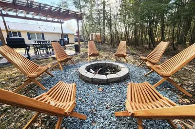 a group of chairs sitting around a fire pit at Lake Access! Catskill Cozy Home- Hot-Tub, Sauna in Loch Sheldrake