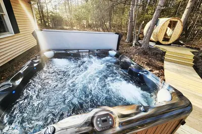 a hot tub in the backyard of a house at Lake Access! Catskill Cozy Home- Hot-Tub, Sauna in Loch Sheldrake