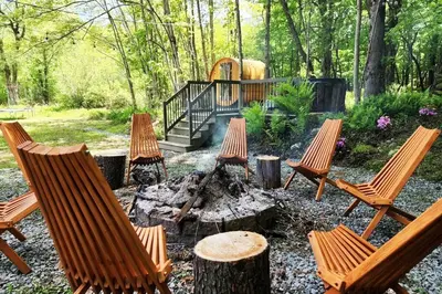 a group of chairs around a fire pit at Serene 3-Bedroom Home with Dome, Hot Tub, Sauna in Hurleyville