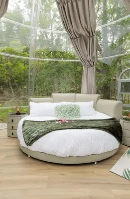 a bedroom with a large bed in front of a window at Serene 3-Bedroom Home with Dome, Hot Tub, Sauna in Hurleyville