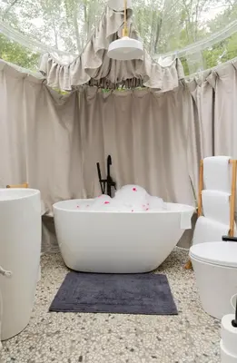 a bathroom with a bath tub and a toilet at Serene 3-Bedroom Home with Dome, Hot Tub, Sauna in Hurleyville