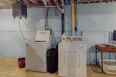 a laundry room with a washing machine and a washer at The Cozy Cabin in Albrightsville