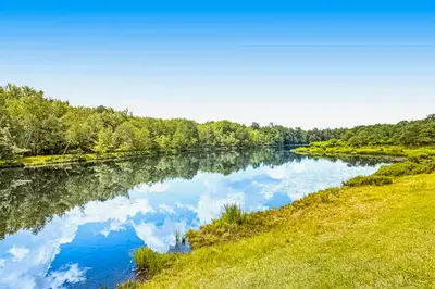 a river with reflections of clouds in the water at The Cozy Cabin in Albrightsville