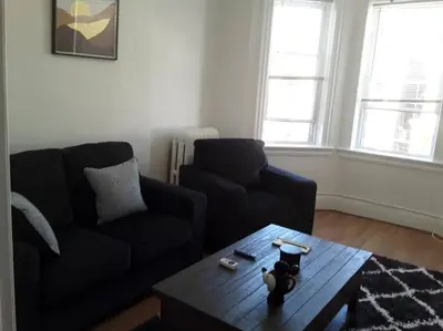 a living room with a couch and a coffee table at Warm 3 BR for U Near Manhattan View, 15 Min to NYC in West New York