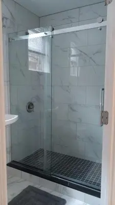 a shower with a glass door in a bathroom at Warm 3 BR for U Near Manhattan View, 15 Min to NYC in West New York