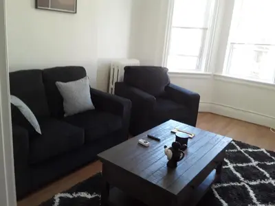 a living room with a couch and a coffee table at Warm 3 BR for U Near Manhattan View, 15 Min to NYC in West New York