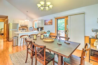 a kitchen and dining room with a table and chairs at Walk to Wolf Run Lake Cottage with Furnished Deck in Albrightsville