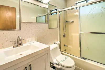 a bathroom with a toilet and a sink and a shower at Walk to Wolf Run Lake Cottage with Furnished Deck in Albrightsville