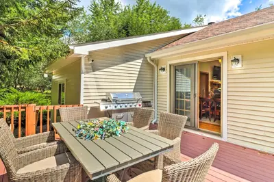 a patio with a table and chairs and a grill at Walk to Wolf Run Lake Cottage with Furnished Deck in Albrightsville