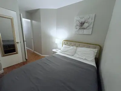 a bedroom with a bed with a picture on the wall at The Cityline Residences in New York