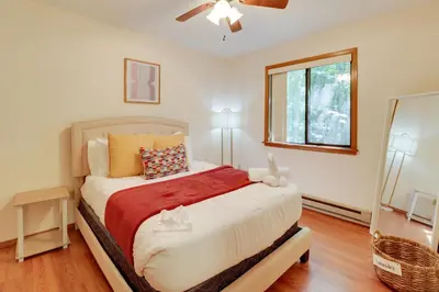 a bedroom with a bed and a window at Poconos Cabin Serene Deck, Fire Pit and Game Room in Tobyhanna