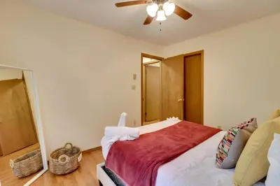 a bedroom with a bed and a ceiling fan at Poconos Cabin Serene Deck, Fire Pit and Game Room in Tobyhanna