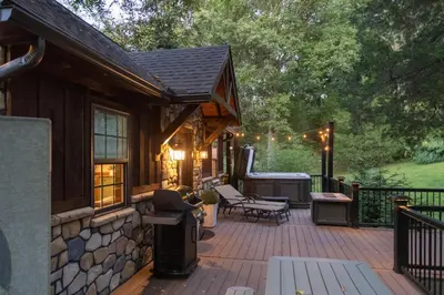 a large wooden deck with a house at Pet-Friendly Delta Cabin with Private Hot Tub! in Delta