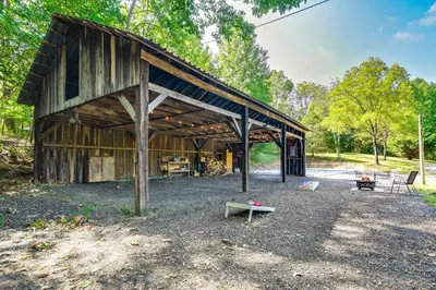an old barn with a bench in front of it at Pet-Friendly Delta Cabin with Private Hot Tub! in Delta