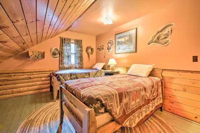 a bedroom with two beds in a room at Handcrafted Log Cabin in Candor Group Getaway! in Candor