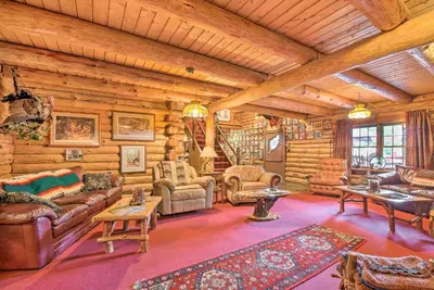 a living room filled with furniture in a log cabin at Handcrafted Log Cabin in Candor Group Getaway! in Candor