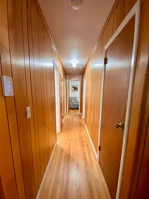 a hallway with wooden floors and a door at Escape to a 3-Bedroom Cabin in Lower Catskills in Woodridge